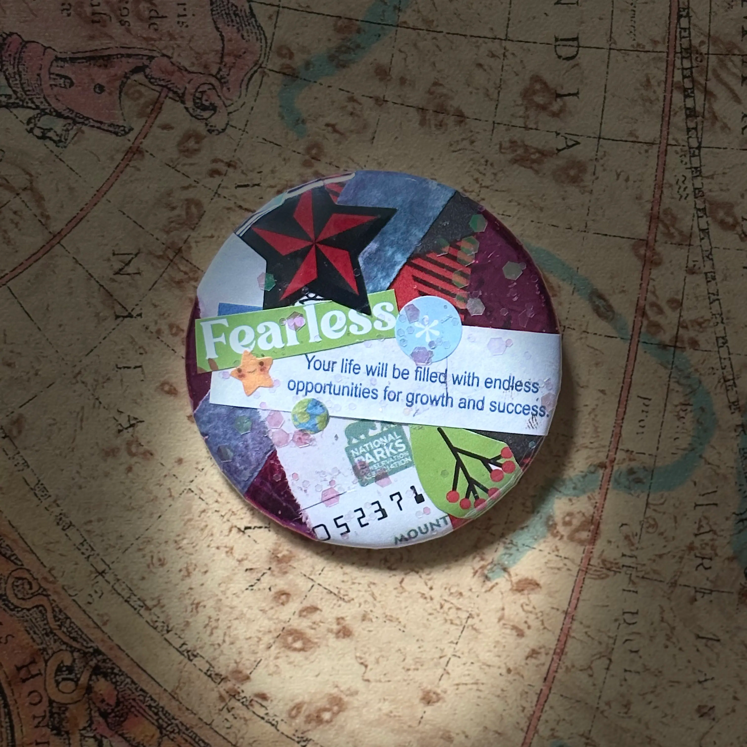 Collage pin with the word Fearless and a paper fortune