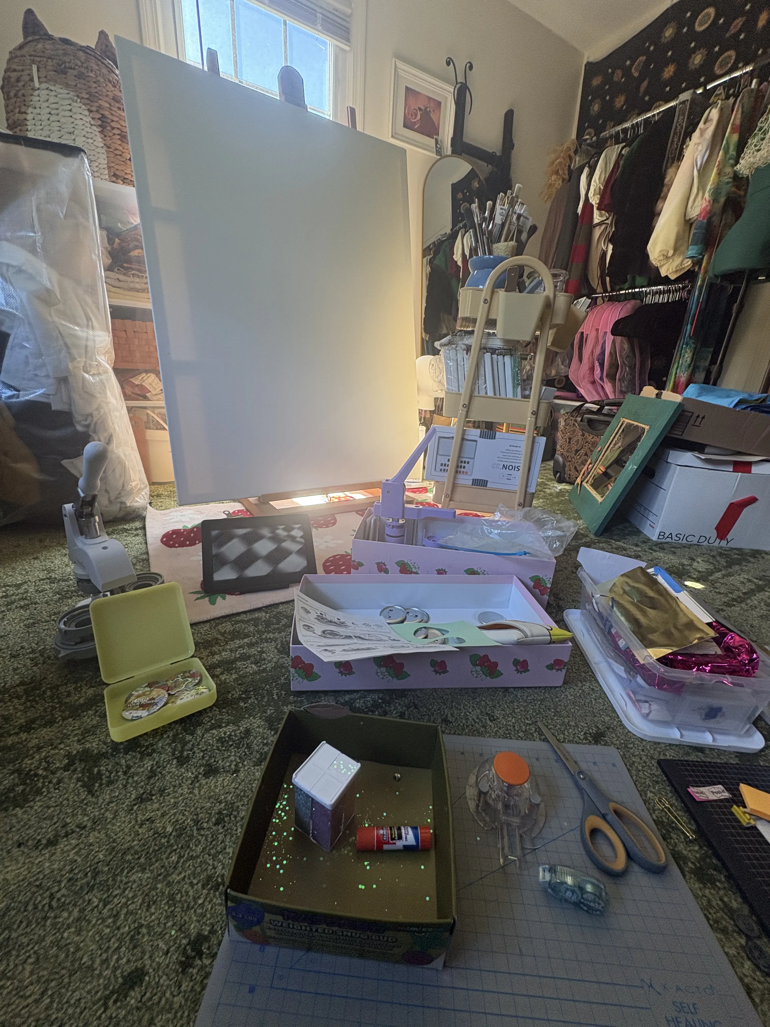 Scattered art materials and an easel in the resident's workspace